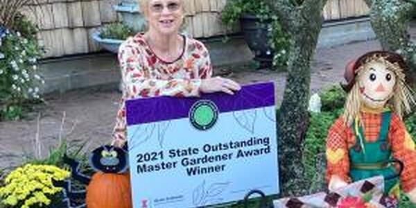 Michelene Koch by her award sign